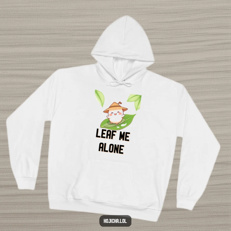 Funny mochi character surfing a tea leaf, wearing a straw hat, on a cozy hoodie.