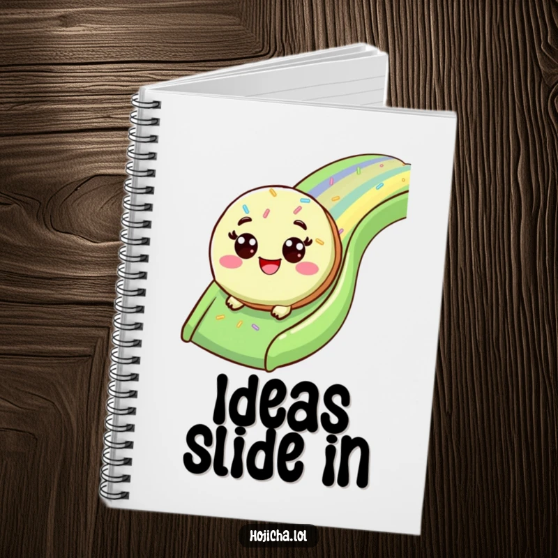 Funny matcha cookie sliding down a sprinkle slide, on the cover of a notebook.